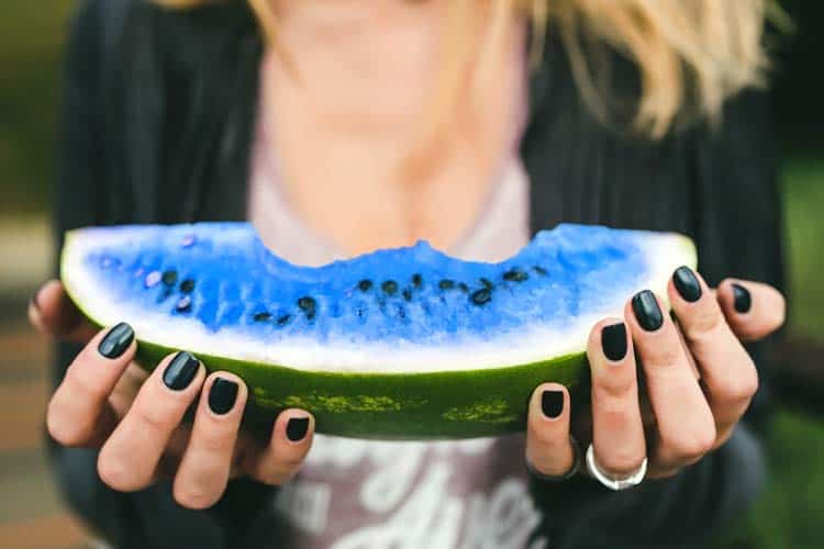 woman holding blue watermelon