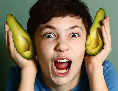 boy playing with avocado