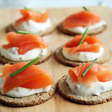 canapés made with crackers, salmon, and cream cheese