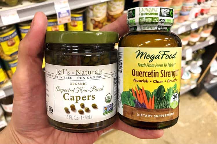 holding organic capers jar and quercetin supplement