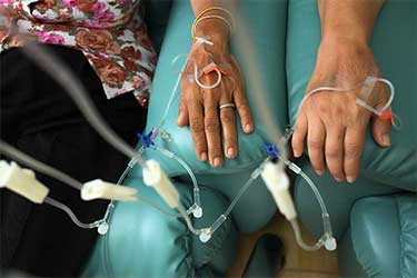 two patients in chair getting chemotherapy