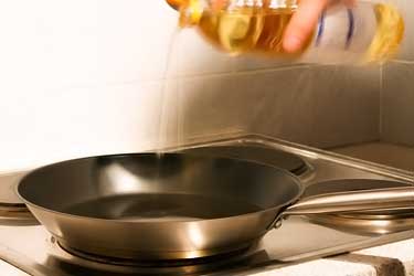 pouring cooking oil into frying pan