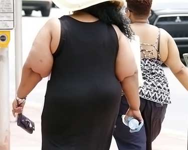 fat women walking on sidewalk