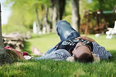 man taking nap in park