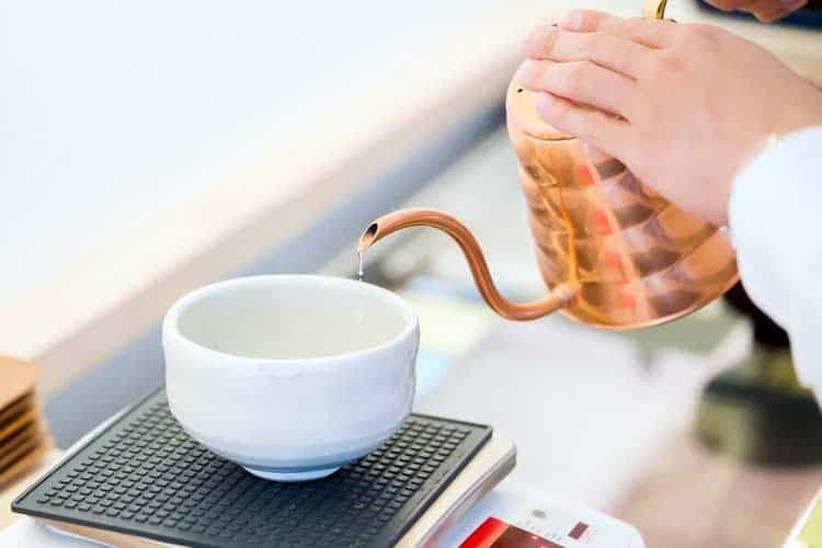 pouring warm water into tea bowl