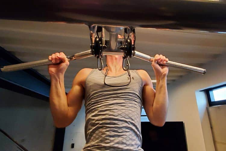 doing pull-ups wearing Aircom wireless headset