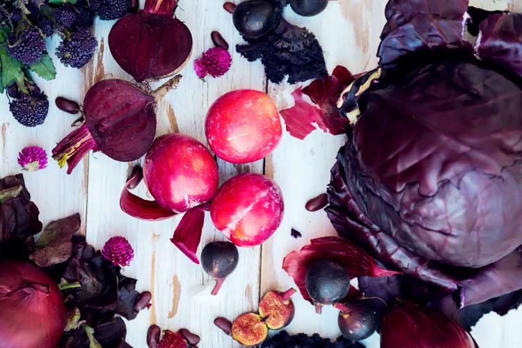 various fresh purple veggies on table