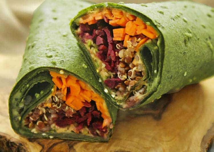 raw wrap filled with veggies and quinoa