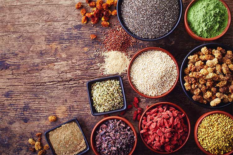 various raw superfoods on countertop