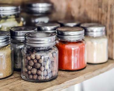 spice shelf with black peppercorn, red cayenne pepper, and garlic powder