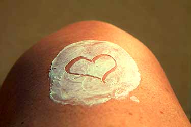 sunscreen on knee with heart